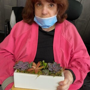 Angela proudly displaying her horticulture creation